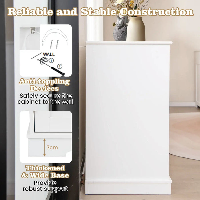 White side cabinet with thick base and anti-toppling devices securing it to wall, decorated with vase and dried flowers