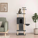 Tabby cat on dark grey multi-level cat tree with house and ladder in modern living room