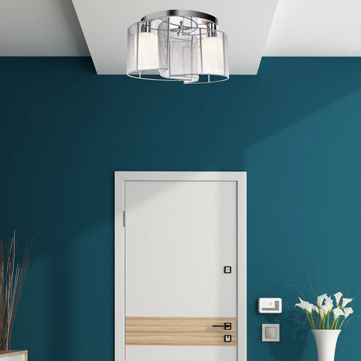Ceiling light fixture in a room with blue walls and a white door.