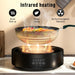 Black ceramic hob and electric grill with infrared heating cooking shrimp and vegetables