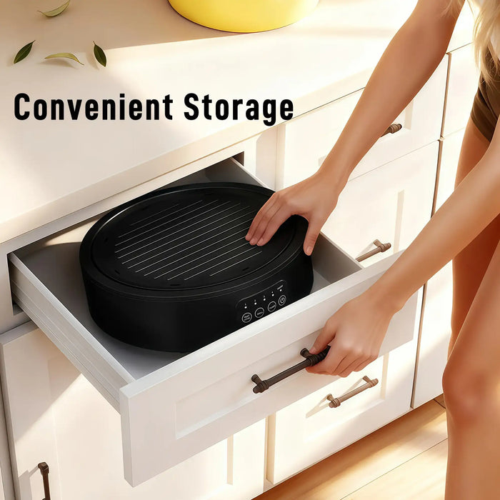 Black dual-mode ceramic hob and grill stored in a white kitchen drawer with convenient storage