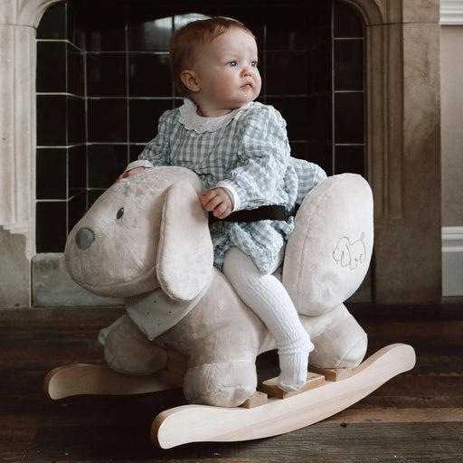 Baby riding plush dog rocker with safety harness and non-tip frame indoors