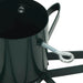 Close-up of black metal Christmas tree stand with silver adjustable eye bolt and support legs
