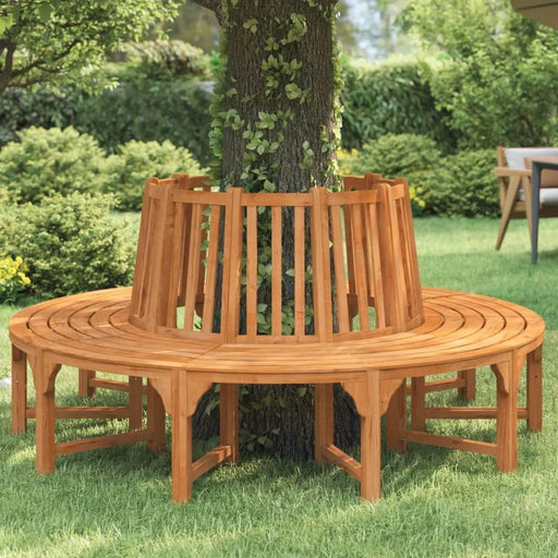 Circular eucalyptus wooden tree bench on green grass in a sunny garden setting