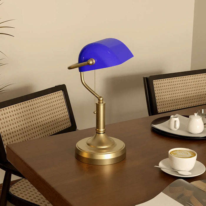 Blue lampshade on a brass base on a wooden table with a cup of coffee and saucer.