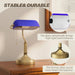 Table lamp with blue glass shade and bronze base on a wooden surface, with text highlighting stability and durability.