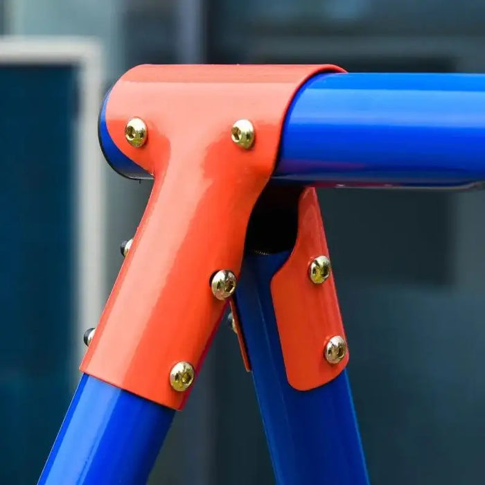 Close-up of a blue metal swing frame with orange joint and gold bolts, outdoor setting