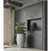 Indoor scene with a large plant in a textured ivory clay flower pot and modern gray decor