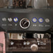 Close-up of a coffee machine with control buttons and settings.