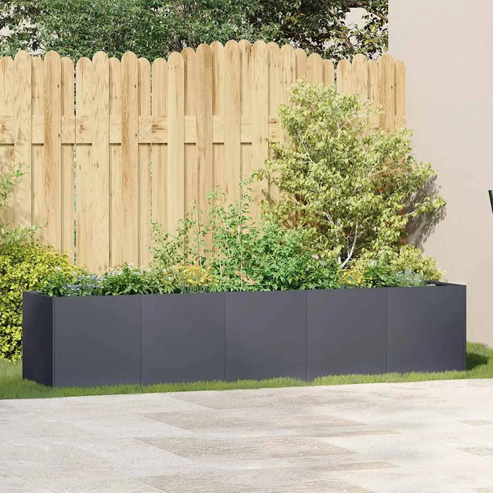 Anthracite cold rolled steel raised garden bed planter with lush green plants against wooden fence