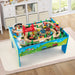 Colorful wooden train table with 84-piece set and tracks in a children's playroom