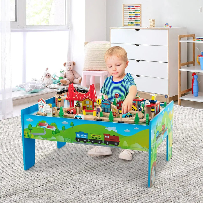 Child playing with colourful wooden train table and 84-piece activity set in playroom