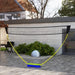 Portable badminton and volleyball net set in modern outdoor patio setting
