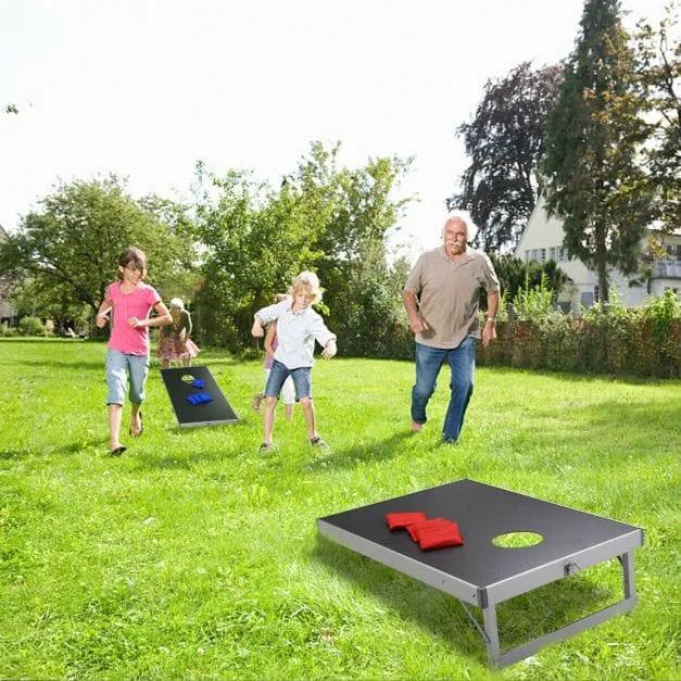 Family playing cornhole game outdoors with aluminum frame and MDF board set on grass