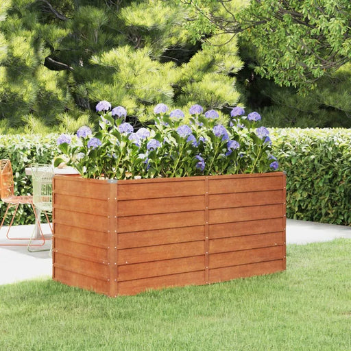Corten steel raised garden bed with purple flowers outdoors on green lawn