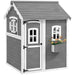 Grey wooden cottage-style playhouse with white trim and flower box under window