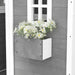 Grey wooden playhouse with white-framed window and flower box, outdoors cottage style