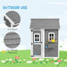 Grey wooden playhouse with tilt roof, fir wood, white trim, flower box, outdoor setting