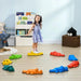 Girl standing on colorful crocodile balance stepping stones for kids in playroom