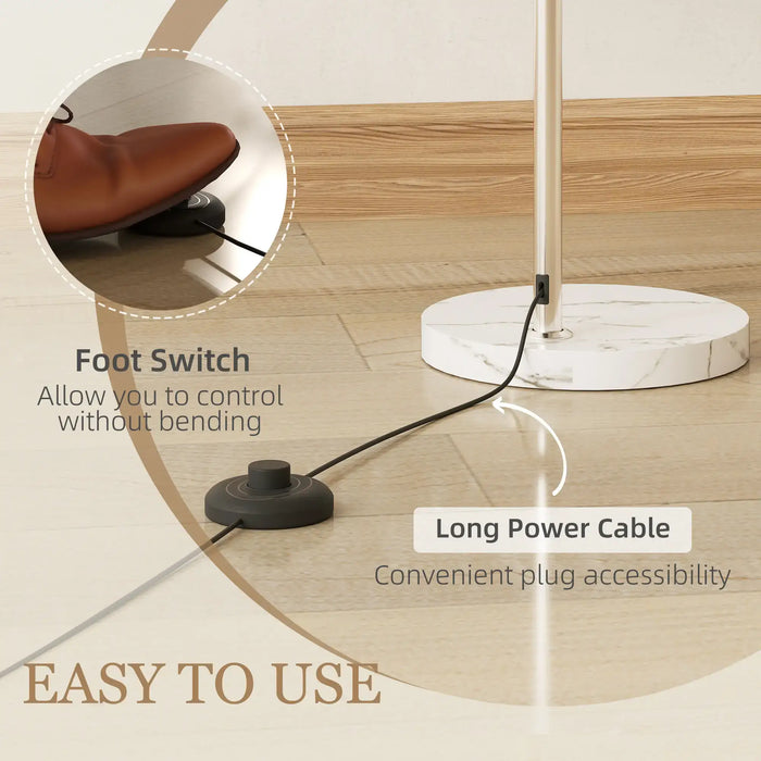 Floor lamp with foot switch and long power cable on a wooden floor.