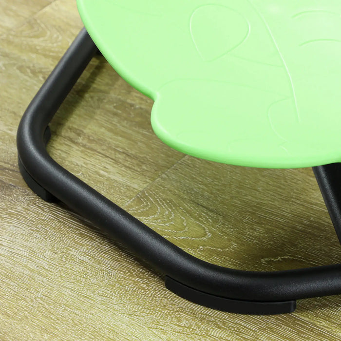Close-up of a green chair seat on a wooden floor