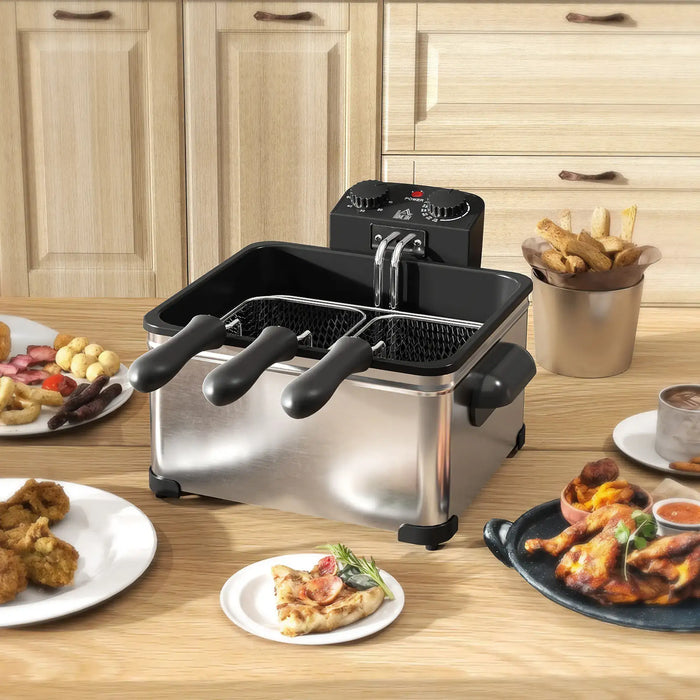 Deep fryer on a kitchen counter with plates of food around it.