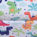 Colorful dinosaur print fabric detail on kids armchair with multicolored cartoon dinosaurs