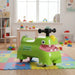 Green children's toy car on a colorful mat in a playroom