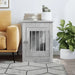 Concrete grey dog crate end table, books and potted plant, modern living room setting