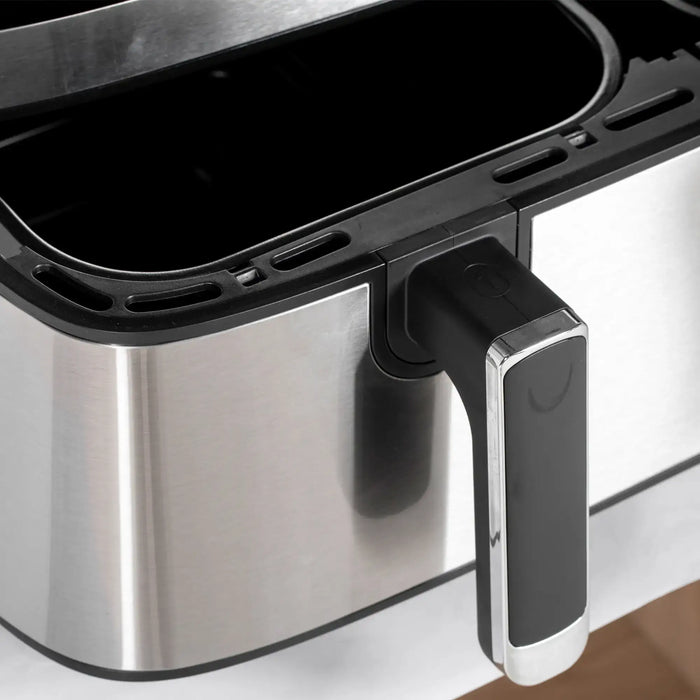 Close-up of a stainless steel appliance with a black handle on a white background