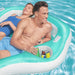 Two adults relaxing on an inflatable pool lounger with cup holders and drinks.