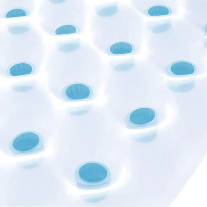 Close-up of white inflatable beach bed with blue air pockets, pool float design