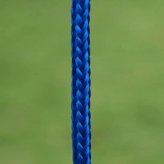 Close-up of a blue braided swing set rope against a blurred green background