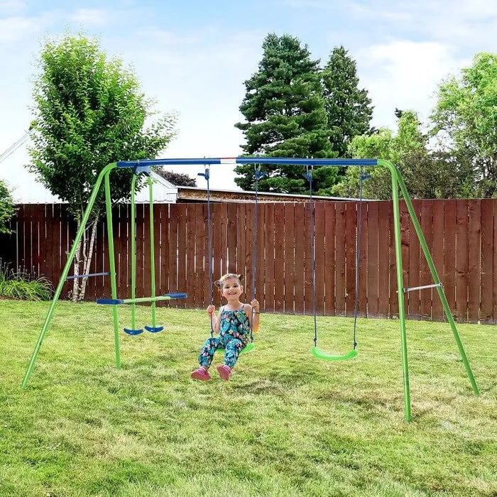 Double swing set with glider in blue and green on grass lawn, child swinging outdoors.