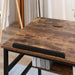 Adjustable industrial drafting table with rustic wood surface and black metal frame
