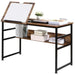 Adjustable industrial drafting table with wooden shelves, black metal frame, and books