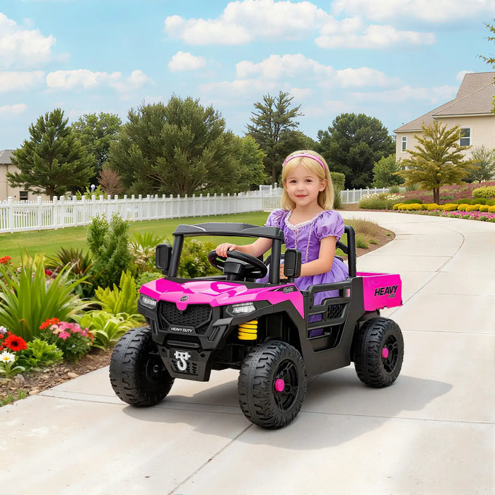 Child in a pink and black toy vehicle on a driveway with a garden and house in the background