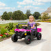 Child in a pink and black toy vehicle on a driveway with a garden and house in the background