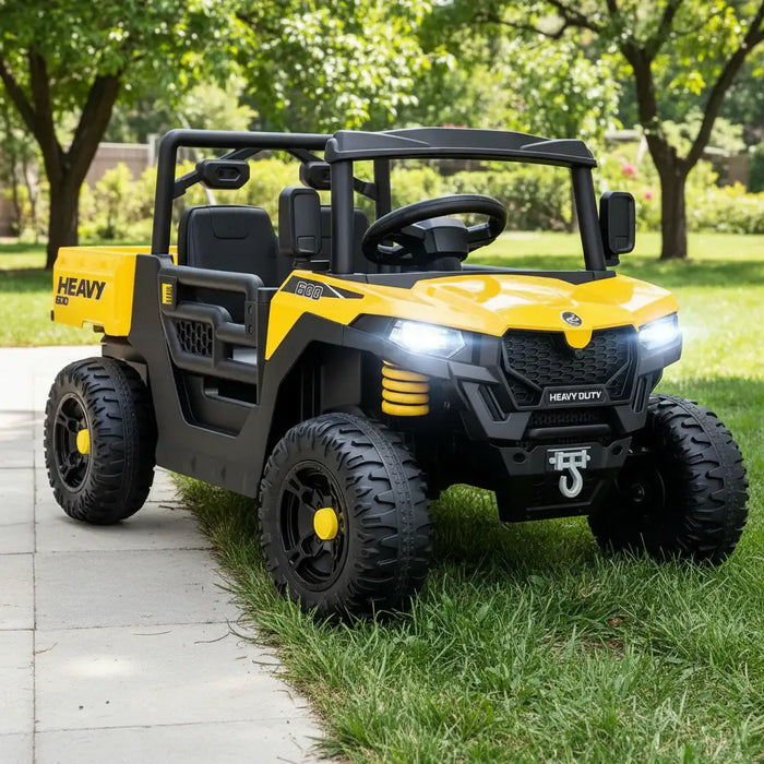 Yellow and black toy off-road vehicle on a grassy area with trees in the background