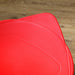 Red cushion on a wooden floor