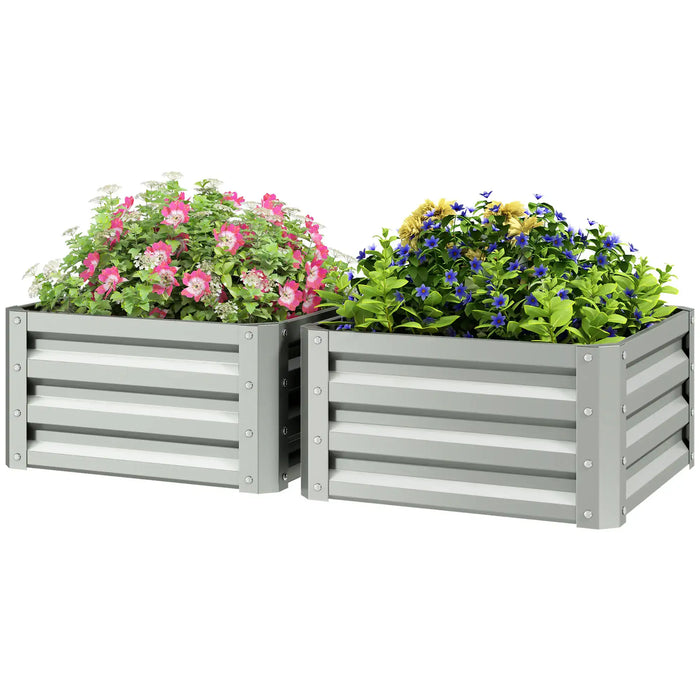 Two gray metal raised garden beds with pink, blue, and yellow flowers and green foliage