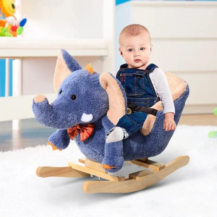 Baby sitting on blue plush elephant rocking horse with wooden base in nursery room