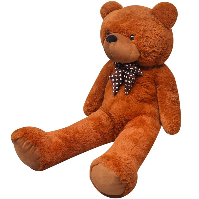 Brown teddy bear with a polka dot bow tie on a white background