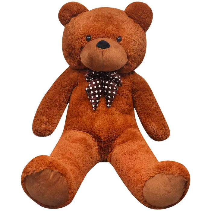 Brown teddy bear with a polka dot bow tie on a white background