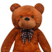 Brown teddy bear with a polka dot bow tie on a white background