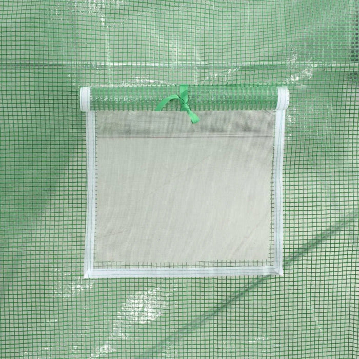 Close-up of a green polytunnel mesh window with roll-up flap and tie on greenhouse cover