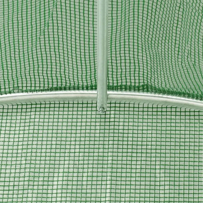 Close-up of green mesh polytunnel greenhouse cover and metal frame structure