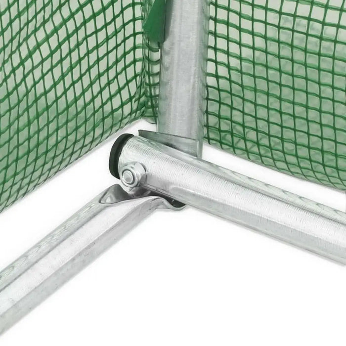 Metal greenhouse frame with green polytunnel mesh cover closeup