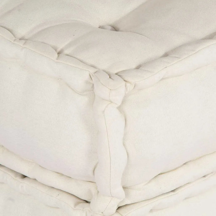 Close-up of a white comforter with visible stitching details.