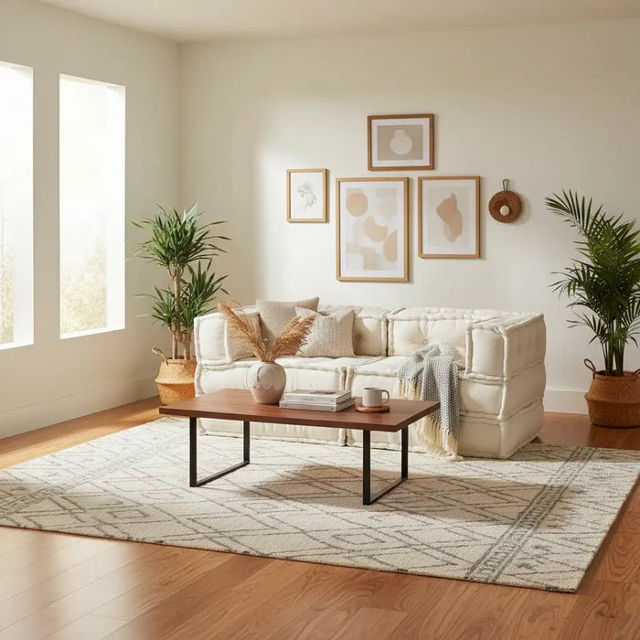 Beige modular sofa in a plush cream lounge with plants